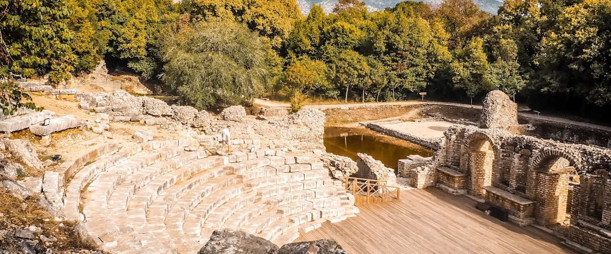 Ancient Greek theater at Butrint, Albania, surrounded by nature and rich with history.